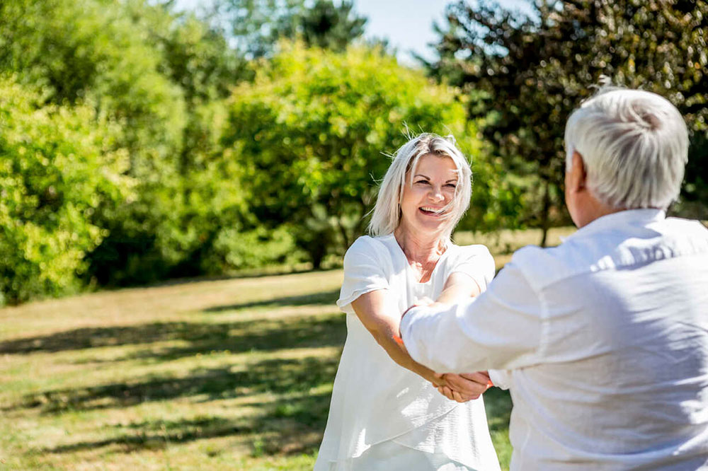 HGH Anti-Aging Dosage Happy Elderly Couple on a Meadow